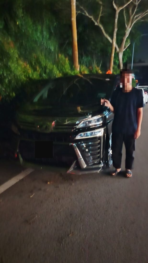 Customer holding the keys beside the Vellfire
