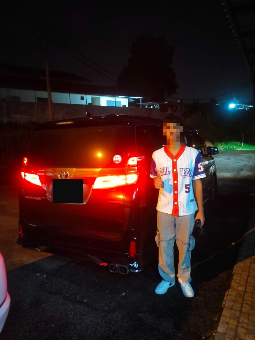 Customer beside the rear of the Vellfire at night
